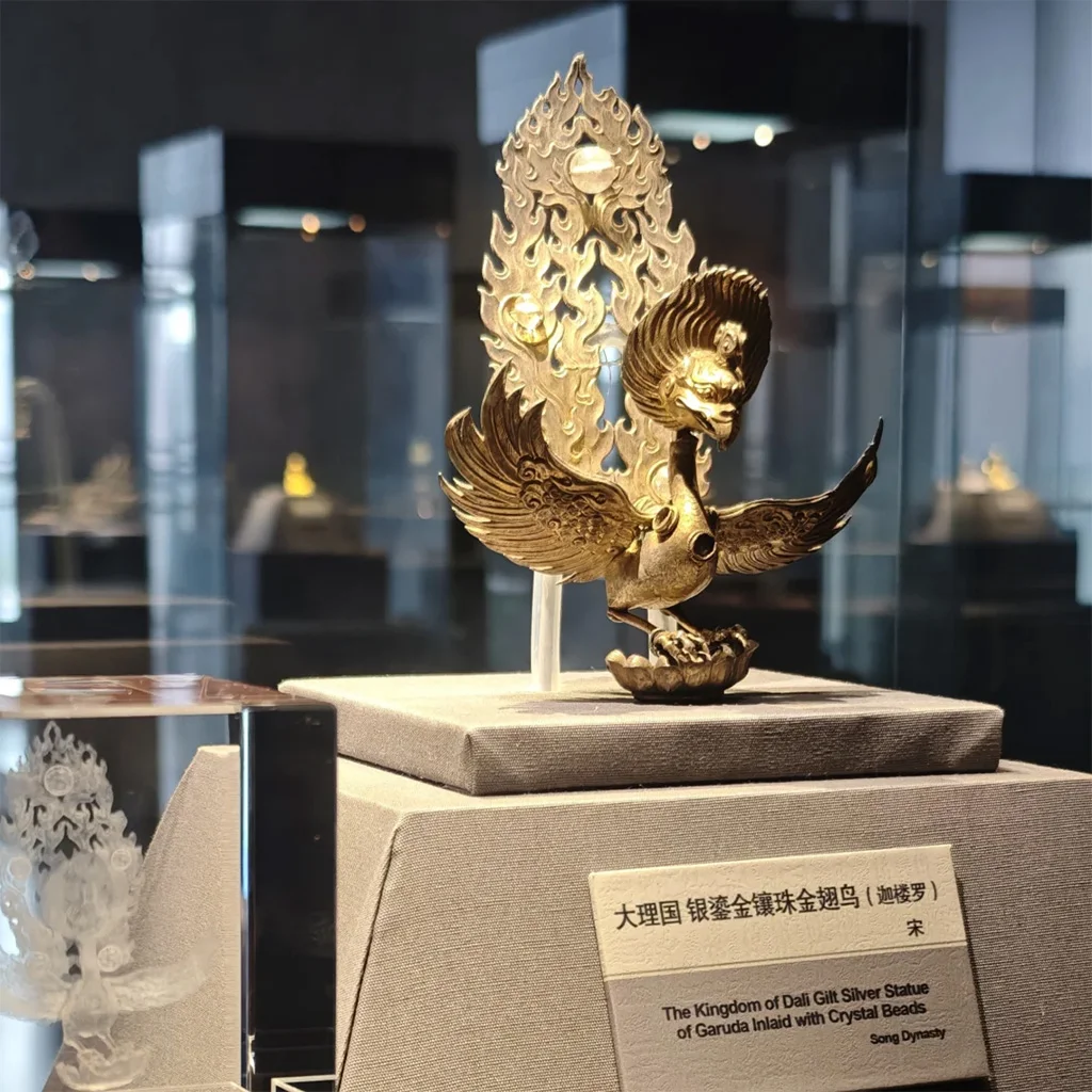 National Treasure Museum2 於 雲南國家寶藏館 展廳中,一件金色迦樓羅造型文物展翅而立,背後火焰紋裝飾華麗,細節精緻,展現濃厚宗教藝術風格。